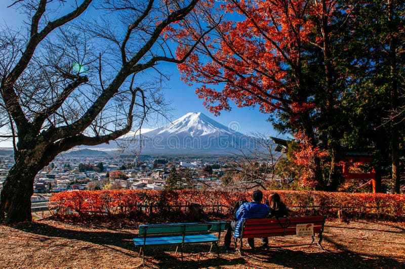 Mount Fuji and red maple tree with sweet couple at Chureito Pagoda Arakurayama Sengen Park - Fujiyoshida