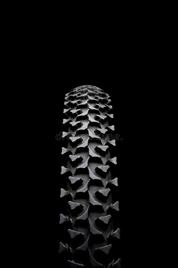 A mountain bike tire on black