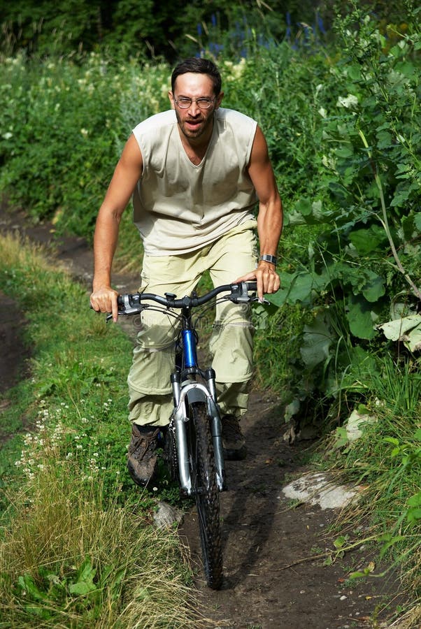 Mountain biker on old road in forest