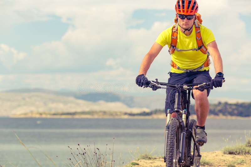 Mountain biker riding on bike at the sea