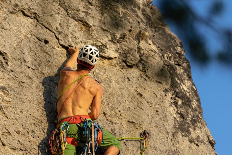 Mountain Climber Climbing the Cliff Using His Climbing Equipment
