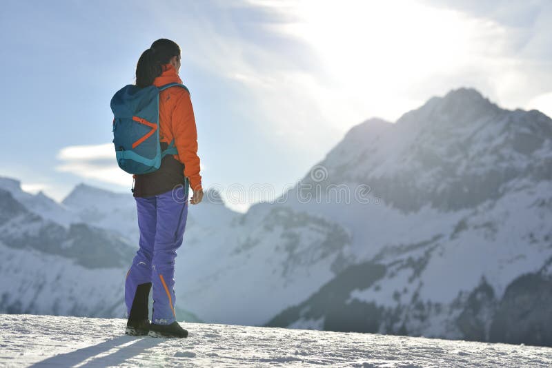 Mountain climber climbing at a snowy ridge