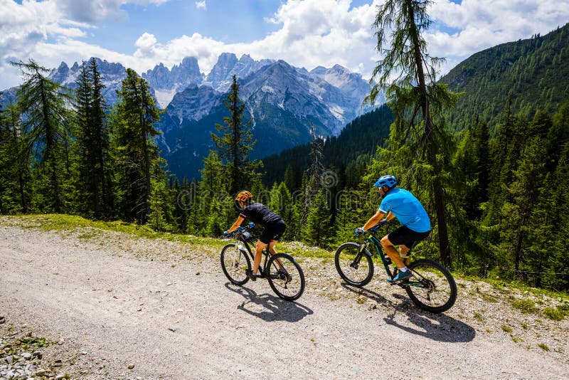 Mountain cycling couple with bikes on track. royalty free stock photo Mountain cycling couple with bikes on track. royalty free stock photo