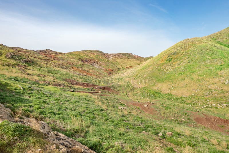 Mountain desert, plain field meadow hill with green grass and red soil royalty free stock images Mountain desert, plain field meadow hill with green grass and red soil royalty free stock images