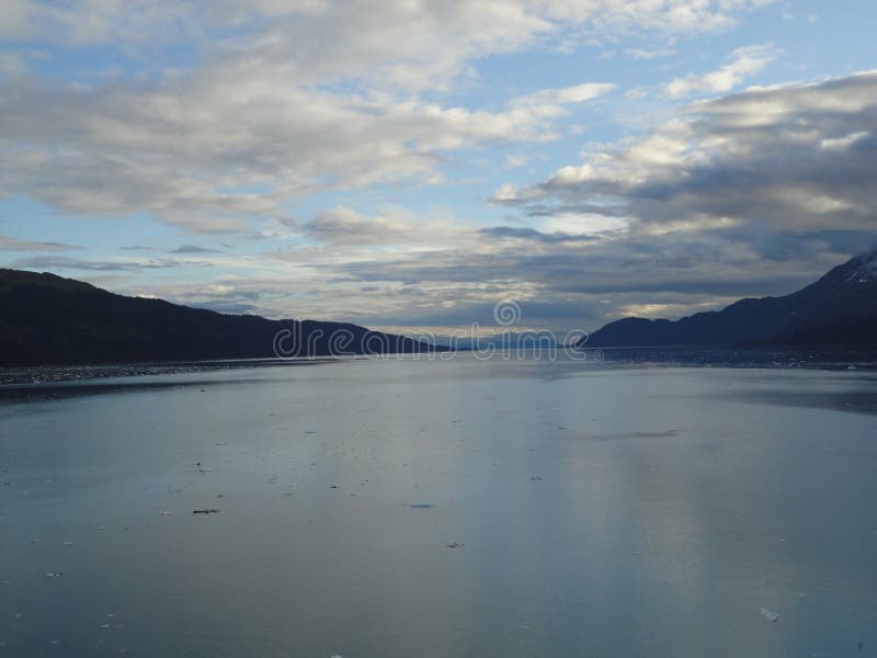 River Passage running up the coast with mountains flanking the sides some with snow capped peaks under a partly cloudy sky. River Passage running up the coast with mountains flanking the sides some with snow capped peaks under a partly cloudy sky.