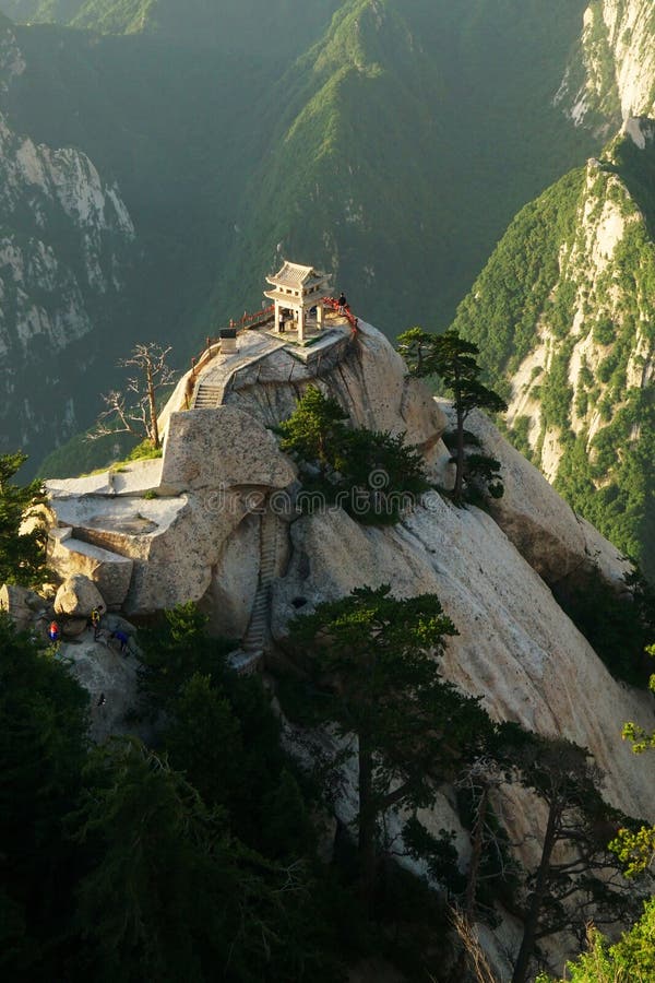 Mountain Huashan Chess Pavilion. Chess Pavilion is on a dangerous place in Mt. Huashan. Mt. Huashan is known as `The Number One Precipitous Mountain under heaven` and one of the five sacred mountains in China. Situated in Huayin City, Mt. Huashan is 120 kilometers 75 miles from Xian. It is famous for natural vista of steep and narrow paths, precipitous crags and a high mountain range. Its five peaks are the representative attractions and each has its distinctive charms: East Peak is the best place to enjoy the sunrise; South Peak has the highest altitude; West Peak is the most elegant; North Peak is famous as the Cloud Terrace Peak and Middle Peak is also called Jade Lady Peak. Taken in the east peak of Huashan Mountain.