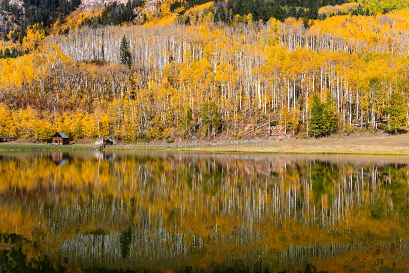 Mountain Lake with Fall Colors and Scenic Landscape Reflection Stock