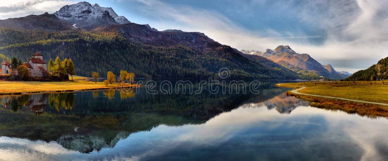 Mountain lake panorama with mountains reflection.