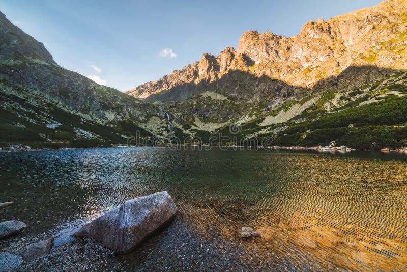 Mountain Lake with Rock in Foreground at Sunset