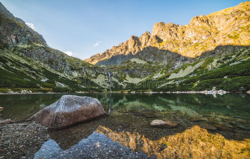 Mountain Lake with Rock in Foreground at Sunset