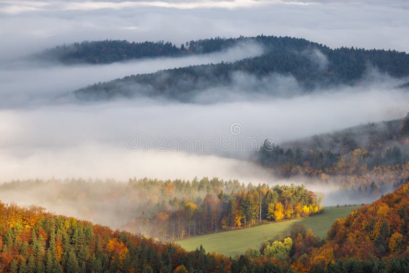 Mountain landscape with foggy valley during autumn morning