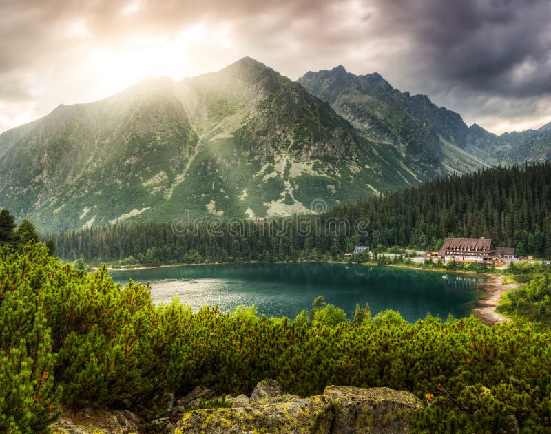 Mountain landscape with pond and mountain chalet