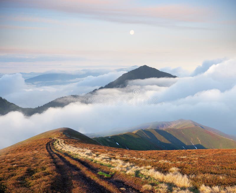 Mountain landscape with road and beautiful fog