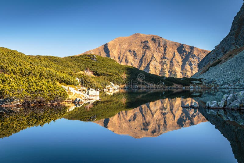 Mountain landscape with tarn at autumn.