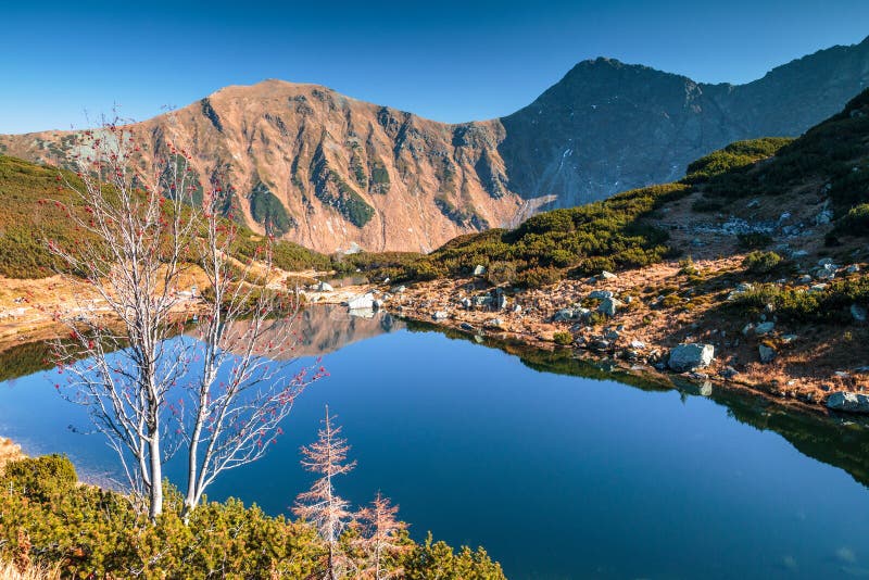 Mountain landscape with tarn at autumn.