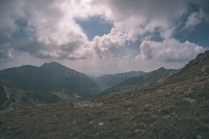 Mountain panorama from top of Banikov peak in Slovakian Tatra mountains with rocky landscape and shadows of hikers in bright day