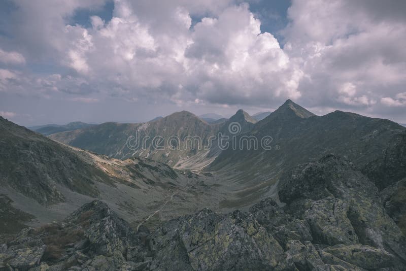 Mountain panorama from top of Banikov peak in Slovakian Tatra mountains with rocky landscape and shadows of hikers in bright day