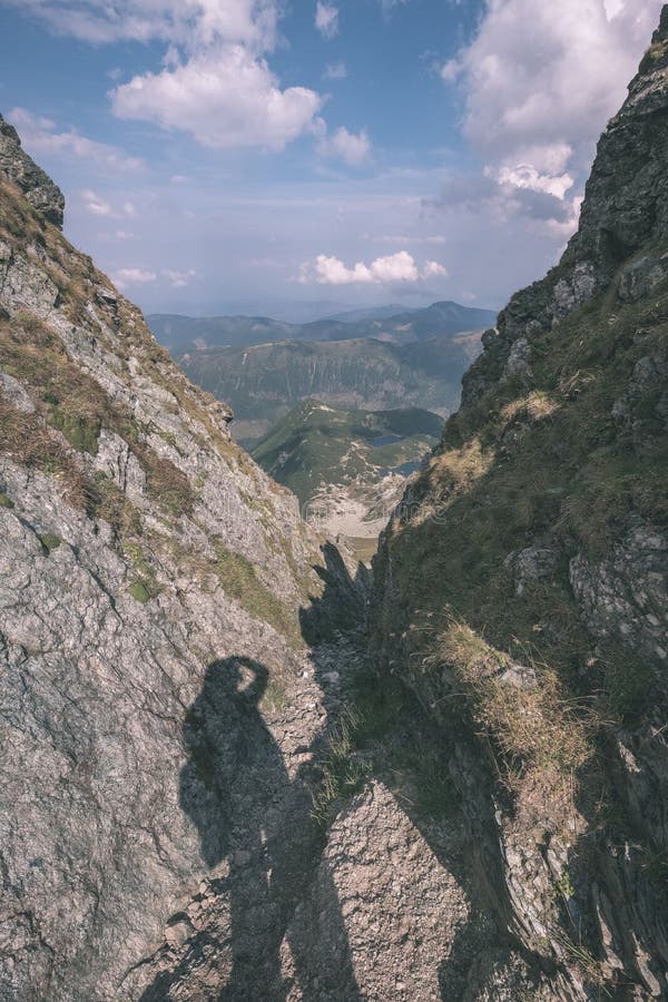 Horské panorama z vrcholu baníkov ve slovenských tatrách se skalnatou krajinou a stíny turistů za jasného dne