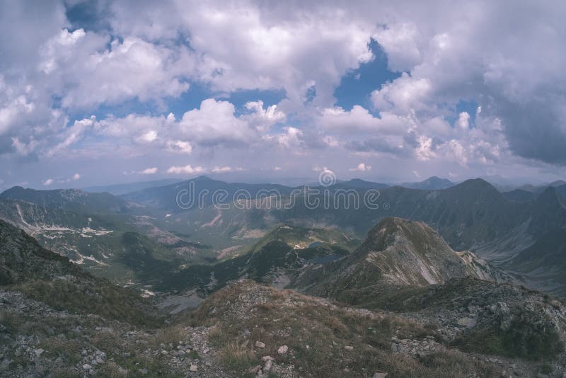 Mountain panorama from top of Banikov peak in Slovakian Tatra mountains with rocky landscape and shadows of hikers in bright day