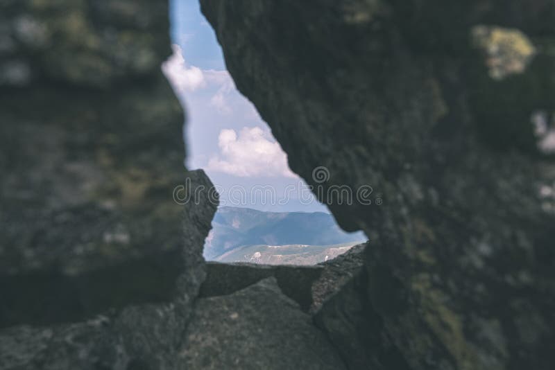 Mountain panorama from top of Banikov peak in Slovakian Tatra mountains with rocky landscape and shadows of hikers in bright day