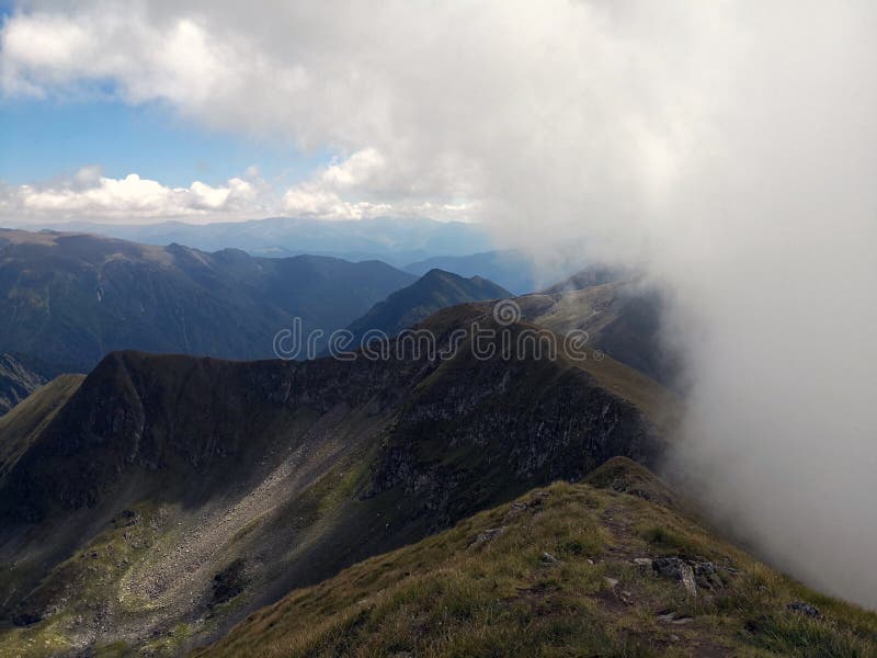 Mountains ridges and peeks surrounded by clouds. Amazing landscape in the mountains. Rea trail stock images, royalty-free photos and pictures