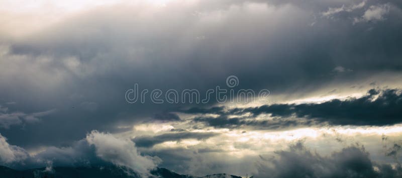 Mountain range with blue sky and heavy clouds. royalty free stock image