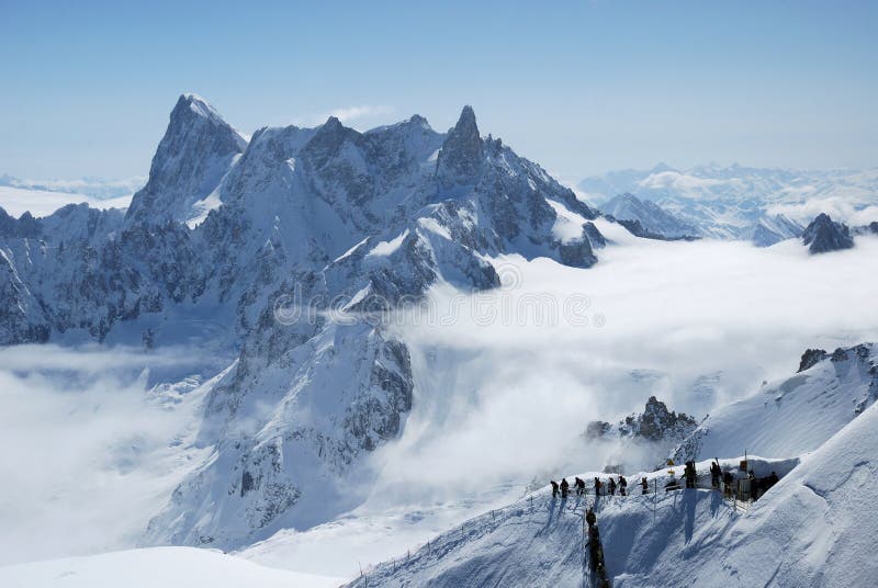 Mountain range between white clouds