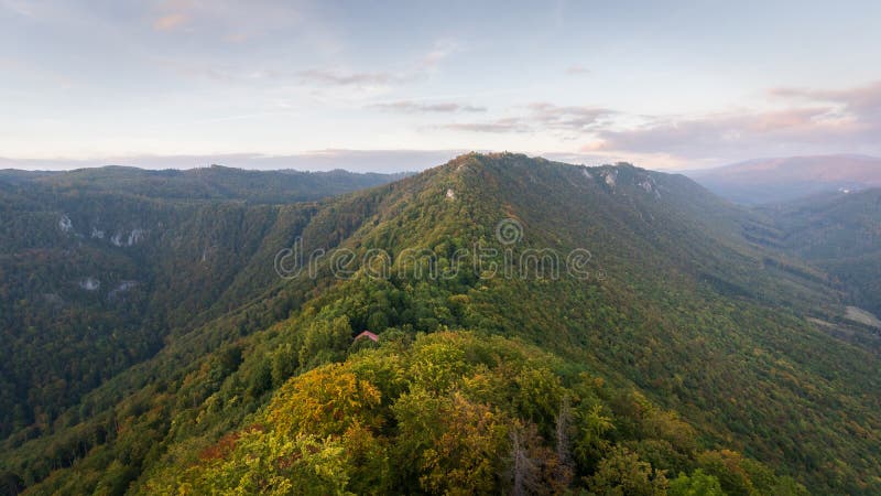 Mountain ridge in dense forest catching last light of the day during autumn sunset,Slovakia, Europe