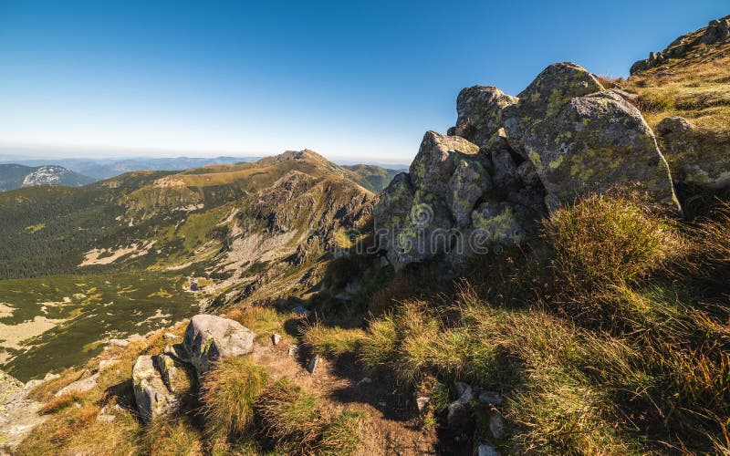 Mountain Ridge with Hiking Trail and Rocks in Foreground