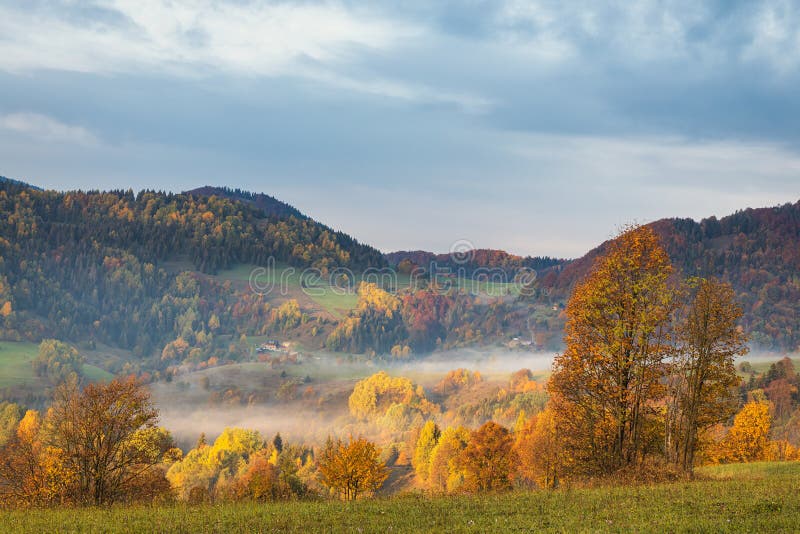 Mountain rural landscape in an autumn foggy morning