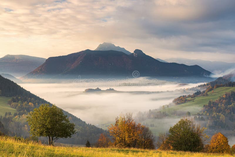 Mountain rural landscape in an autumn foggy morning