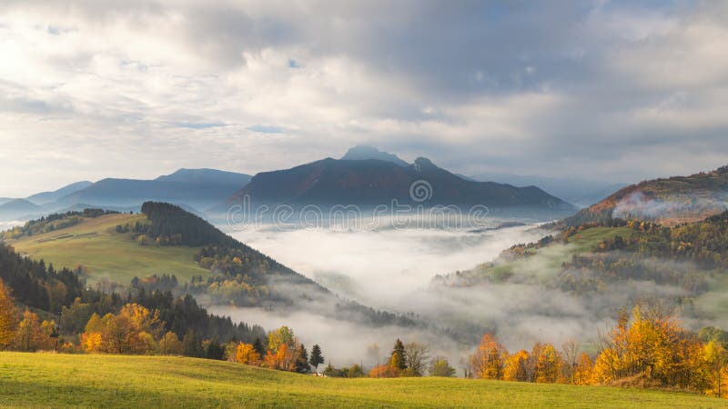 Mountain rural landscape in an autumn foggy morning