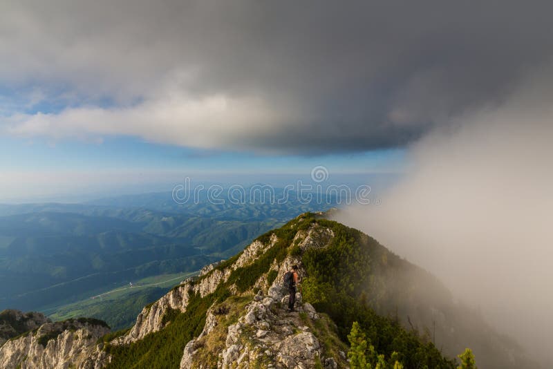 Dramatic alpine scenery in the summer, in the Transylvanian Alps, with clouds and mist