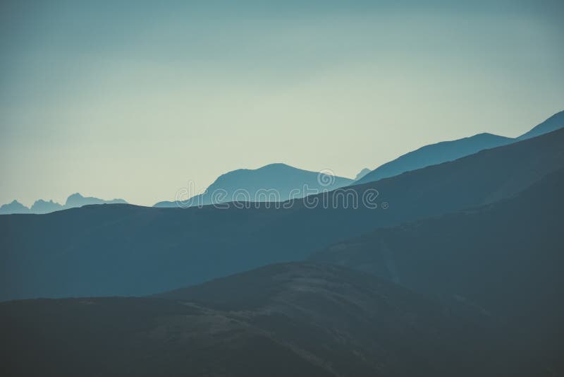 Mountain top panorama in autumn covered in mist or clouds - vin