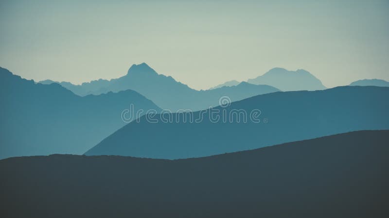 Mountain top panorama in autumn covered in mist or clouds - vin