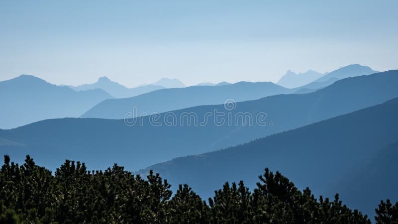 Mountain top panorama in autumn covered in mist or clouds