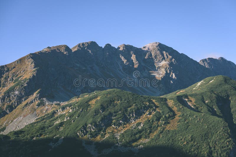 Mountain tops in autumn covered in mist or clouds- vintage effe