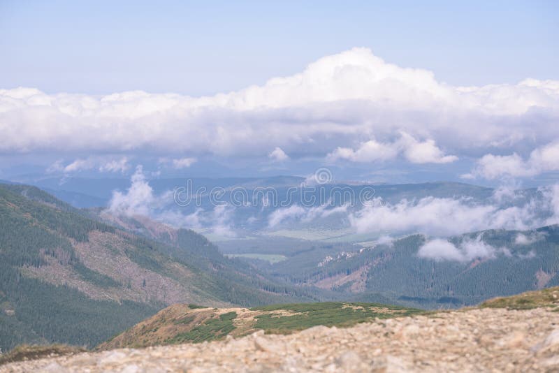 Mountain tops in autumn covered in mist or clouds - vintage ret