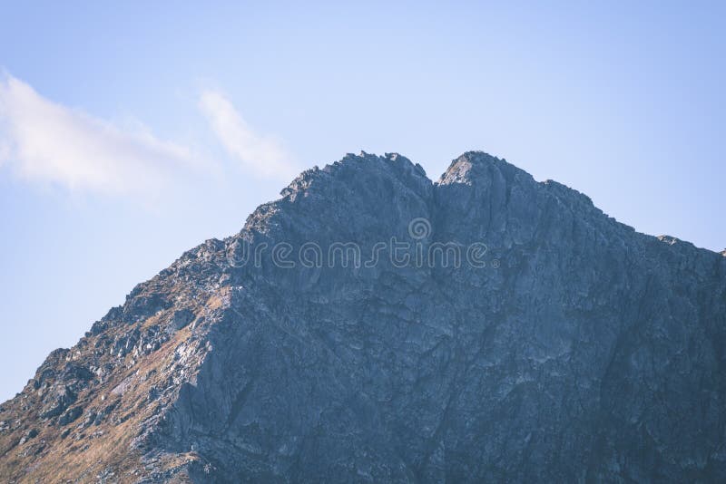Mountain tops in autumn covered in mist or clouds - vintage ret