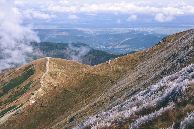 Mountain tops in autumn covered in mist or clouds - vintage ret