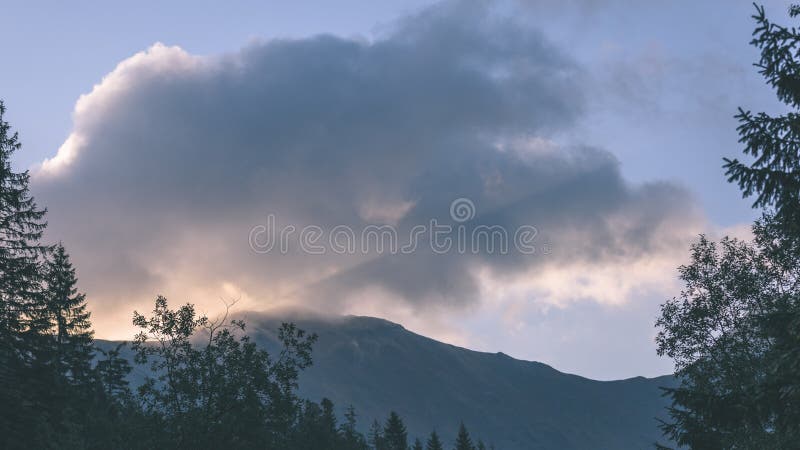 Mountain tops in autumn covered in mist or clouds - vintage ret