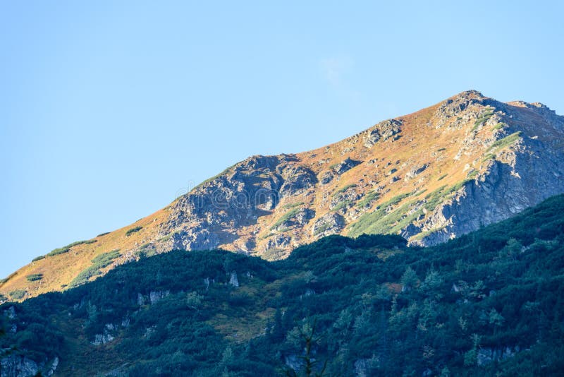 Mountain tops in autumn covered in mist or clouds