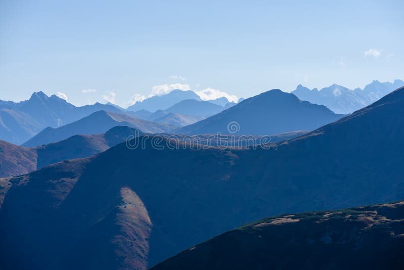 Mountain tops in autumn covered in mist or clouds