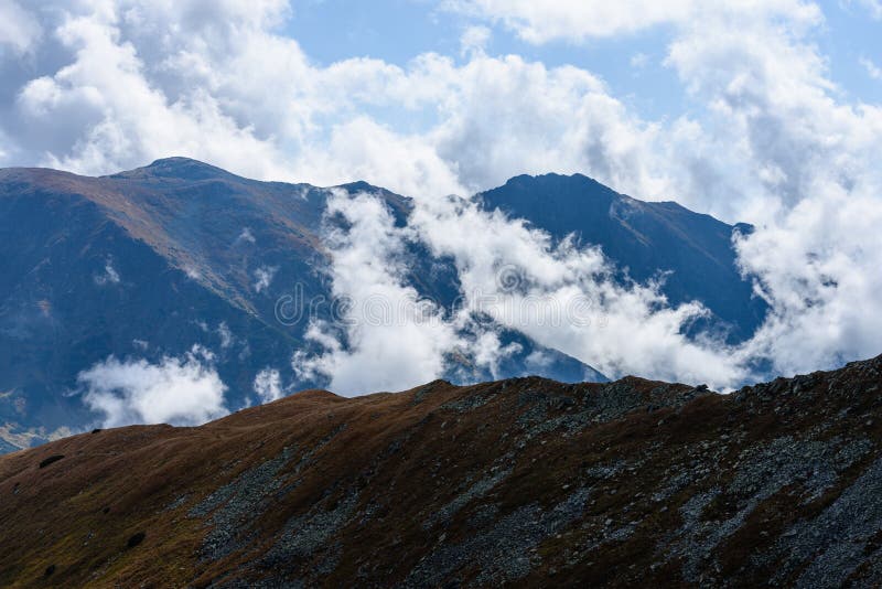 Mountain tops in autumn covered in mist or clouds