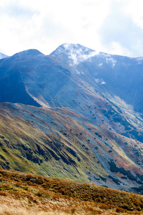 Mountain tops in autumn covered in mist or clouds