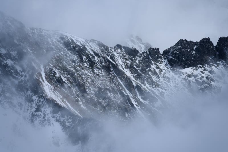 Mountain tops in autumn covered in mist or clouds