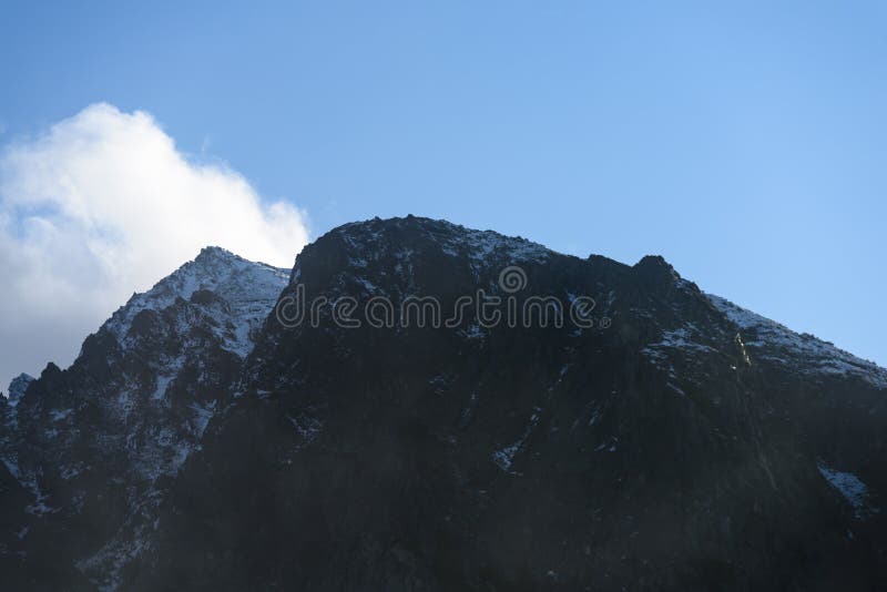 Mountain tops in autumn covered in mist or clouds