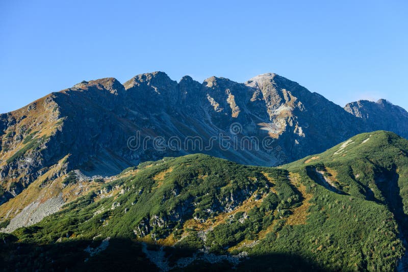 Mountain tops in autumn covered in mist or clouds