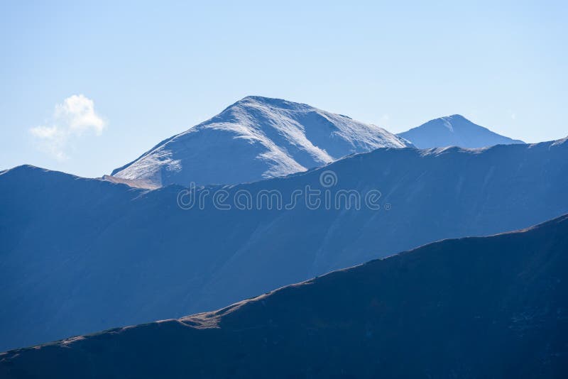 Mountain tops in autumn covered in mist or clouds