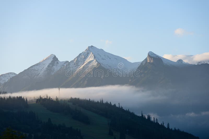 Mountain tops in autumn covered in mist or clouds